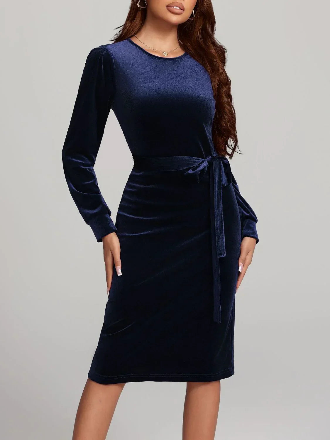 Woman wearing a navy velvet holiday cocktail dress