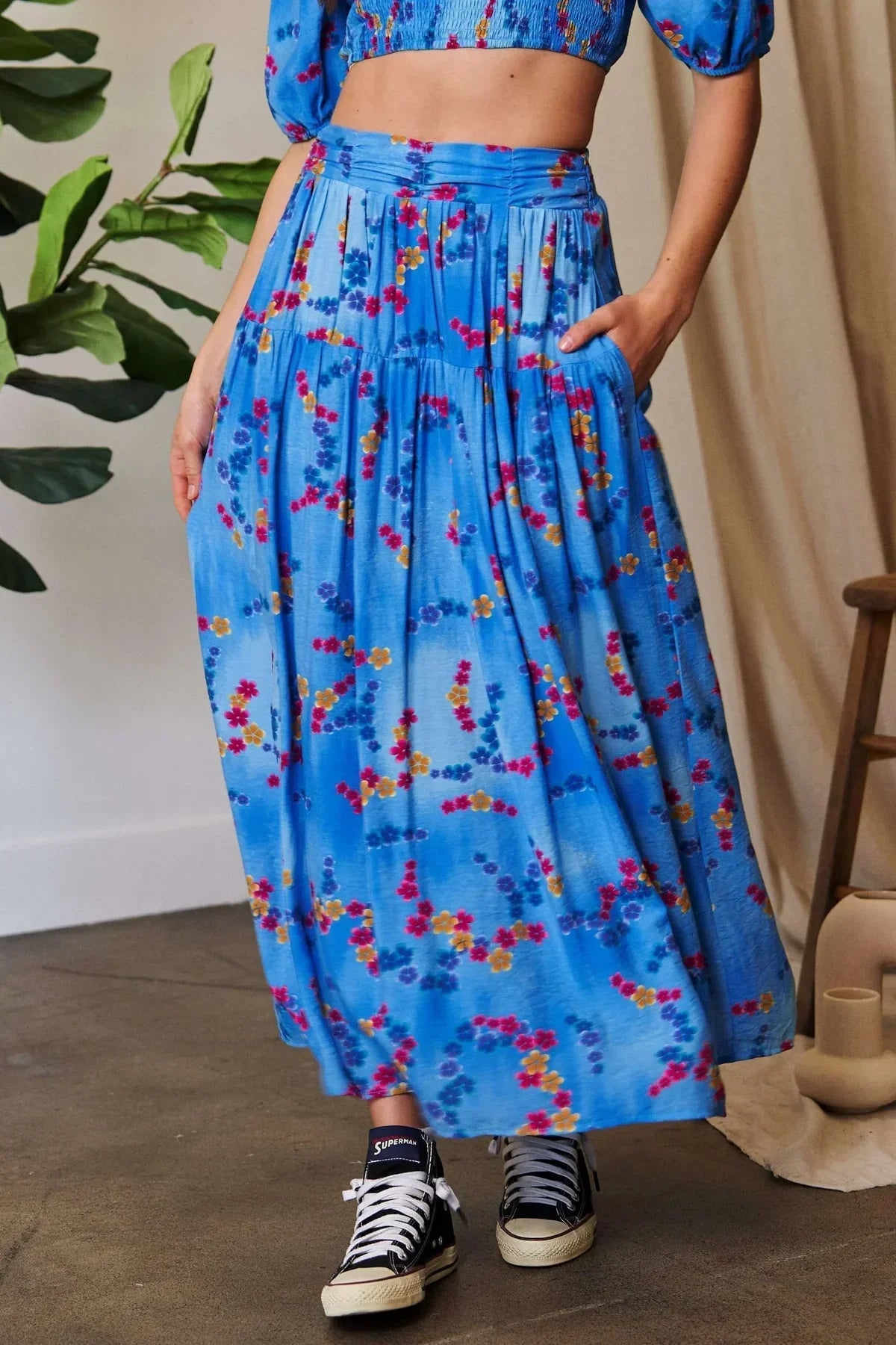 Model wearing casual high-rise women’s bottoms skirt with a crop top